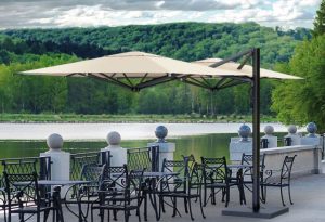 Dual V Carbon 2-Way Side-Arm Parasol in outdoor restaurant scene